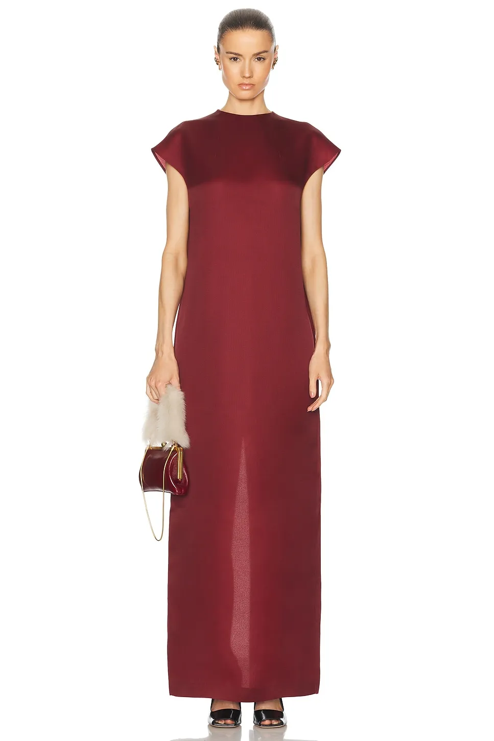 Khaite wool crepe dress, high at the neck and severe from the front.
