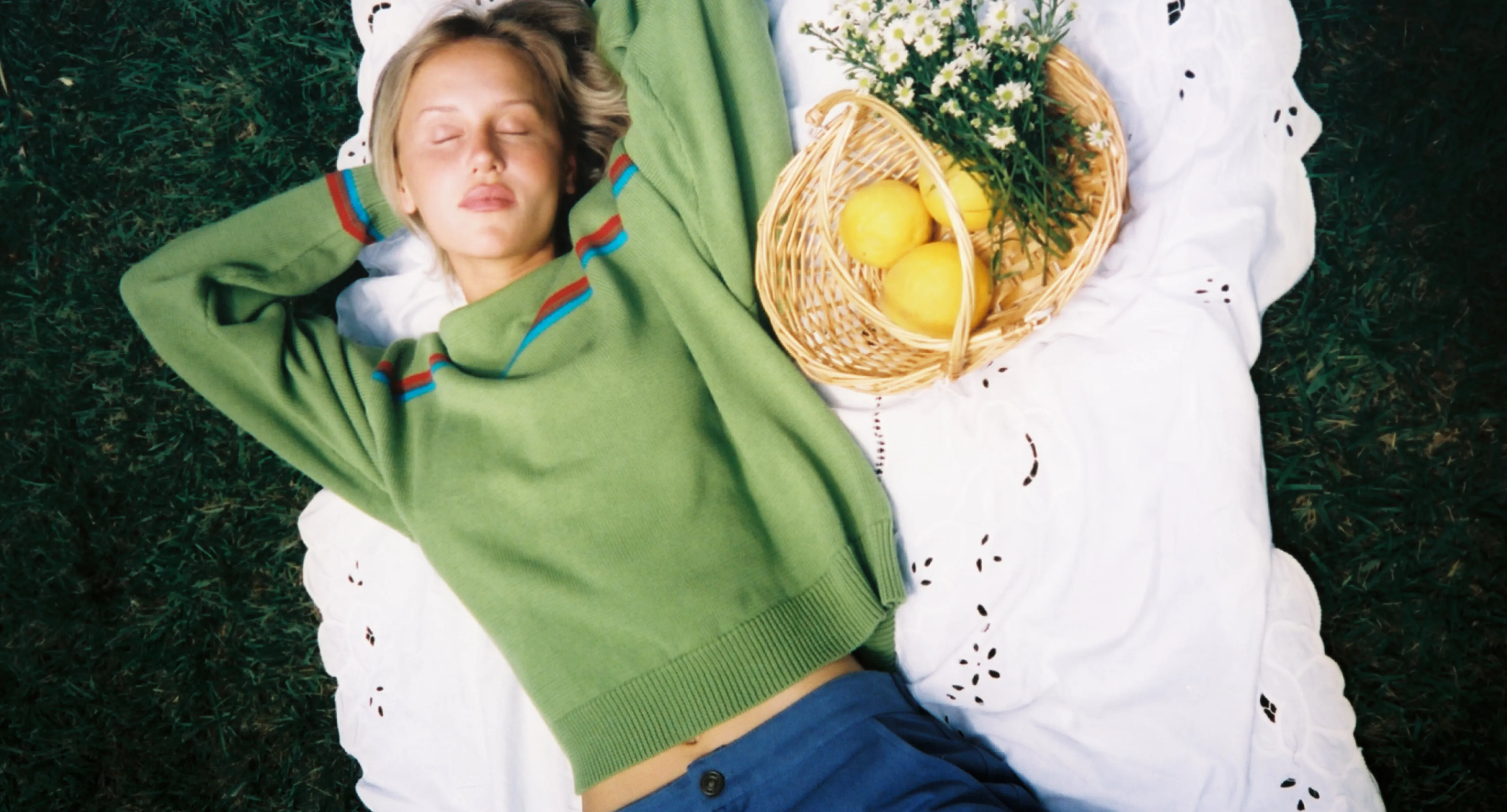 Lisa Says Gah campaign photograph: a green knit sweater, shot outdoors.