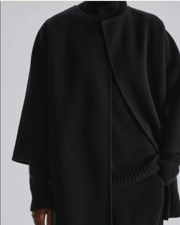 The Row double-faced wool coat in black, open at the front with no fastening.
